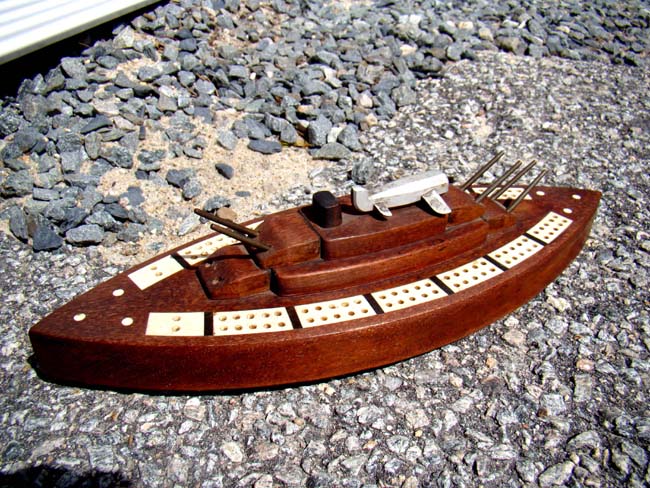 Possibly unique early 20th century bone inlaid cribbage board in the form of a Battleship with deck mounted plane. — image 3
